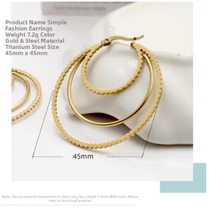 Detailed view of 45mm gold titanium steel triple hoop earrings with beaded texture