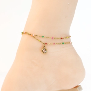 Detail of bohemian double-layer gold anklet with colorful beads and crystal pendant