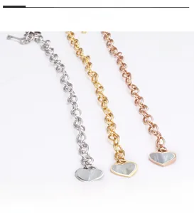 Detailed view of titanium steel bracelets in gold, silver, and rose gold with heart charms