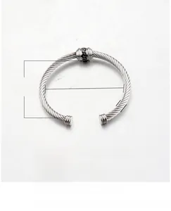 Macro shot of titanium steel cable wire bracelet showing Greek pattern details