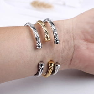 Three-piece stackable twisted cable open bangles in gold and silver stainless steel