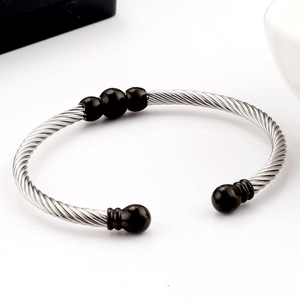 Polished stainless steel cable twist bracelet with black beads in open C-shape design