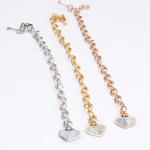Golden titanium steel heart charm bracelet with shell inlay and key clasp design