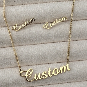 Custom name jewelry set with gold pendant necklace and earrings on beige velvet