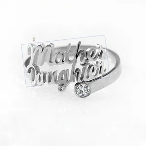 Detailed macro of a silver custom double-layered Mother Daughter ring with a zircon stone