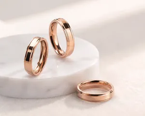 Detailed view of rose gold titanium steel rings with minimalist grooved design