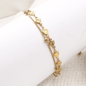 Double-layered 18k rose gold anklet with heart pendant on a white jewelry display