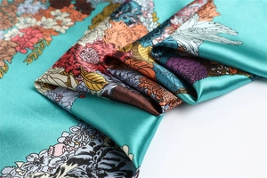Detailed satin texture of tiffany blue floral scarf with elegant flower print details