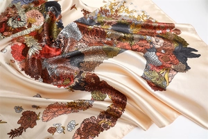 Macro detail of floral and horse print satin scarf showing smooth silk-like texture