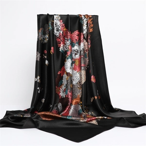 Detail of silk-like satin scarf featuring vibrant floral horse print on black fabric