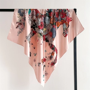 Pink satin silk square scarf featuring vibrant floral horse print on elegant metal display