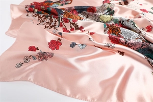 Close-up of pink floral silk scarf showing premium satin texture and flower prints