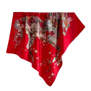 Red square silk scarf featuring a vibrant large floral print and high-gloss finish