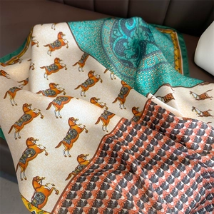 Detailed close-up of silk-textured horse print scarf with retro paisley patterns
