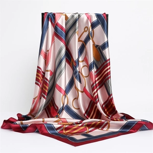 Detail of silk-like satin scarf with classic chain print and elegant drape