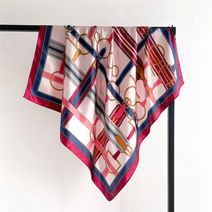 Macro detail of silk-like square scarf featuring classic equestrian stirrup patterns