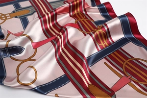 Close-up of elegant satin scarf showing chain patterns and smooth fabric texture