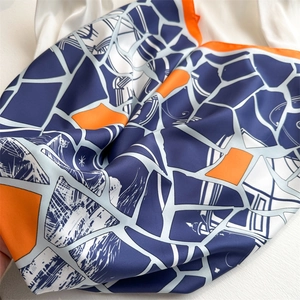 Chic geometric silk-feel scarf in navy blue and orange with a satin finish