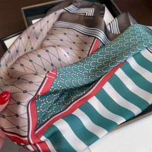 Detail of silk square scarf featuring vintage horsebit chain patterns and green stripes