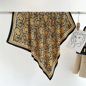 Detail of baroque silk scarf with gold flower patterns and Greek fret border on a hanger