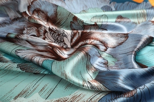 Macro shot of silk scarf showing vintage floral print and smooth fabric texture