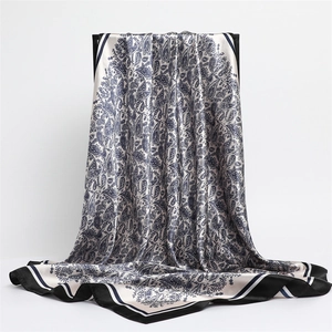 Blue paisley print silk scarf for women with contrast stripe edges and smooth finish