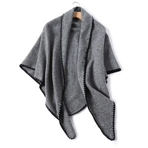 Detailed texture of gray faux cashmere shawl with black contrast blanket stitch edging