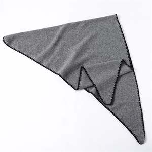 Macro shot of grey triangle scarf texture with black whipstitch embroidery edges