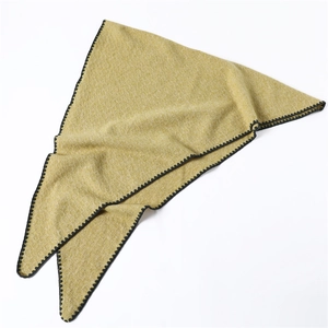 Macro detail of ginger yellow triangle scarf with waffle weave and black scalloped edges