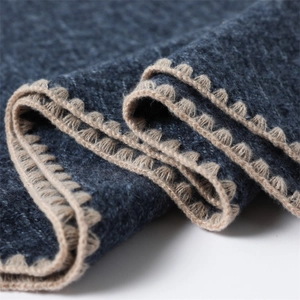 Detail of navy cashmere-feel scarf featuring elegant beige scalloped knit edges