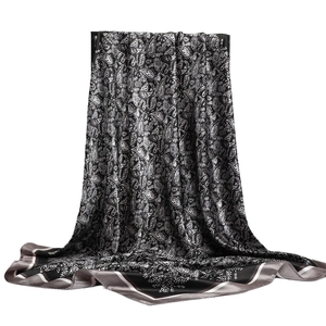 Elegant black and white paisley silk scarf with glossy texture for sun protection