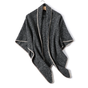 Detail of soft charcoal grey knit shawl with delicate beige scalloped lace edge trim