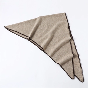 Macro detail of khaki cashmere-like triangle shawl with dark brown crochet scalloped edges