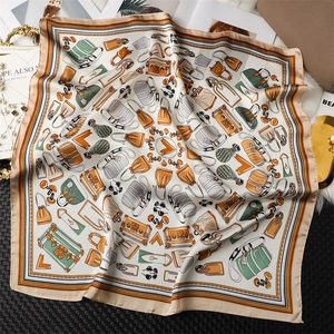 Detailed pattern of a vintage silk-like scarf with classic handbag and luxury motifs