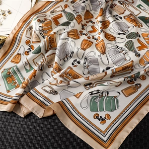 Detailed macro view of retro square silk scarf showing high-quality bag prints and soft texture
