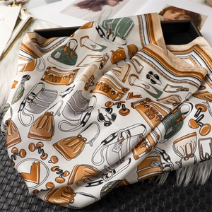 Detailed close-up of a 70cm silk-feel scarf with modern fashion accessory patterns