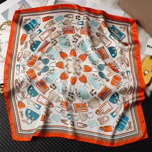 Detailed close-up of retro French silk scarf with orange borders and hand-painted patterns