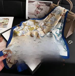 Detailed view of a 70cm silk scarf with iris floral prints and elegant navy blue border