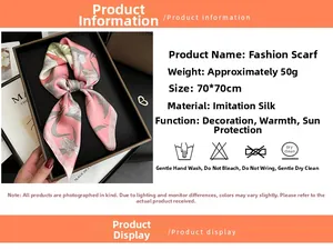 Close-up of a pink floral silk scarf presented in an elegant gift box with magazine