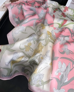 Detail of iris floral print silk scarf with soft pink color blocking and elegant drape
