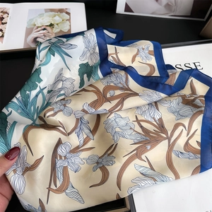 Detail showing smooth silk texture and iris floral pattern of the elegant shawl