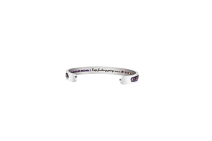 Detail of silver stainless steel cuff bracelet with purple accents and inspirational engraving