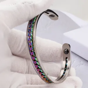 Macro detail of C-shaped stainless steel bracelet with rainbow chain inlay and magnets