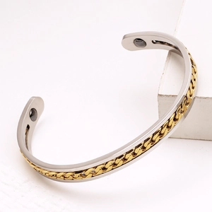 Detail of bicolor stainless steel magnetic cuff with golden chain inlay and inner magnets