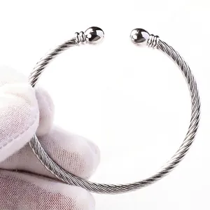 Silver twisted wire C-shape bangle with sphere ends made of polished stainless steel