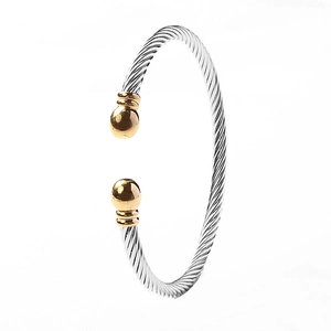 Twisted cable cuff bracelet in silver and gold-tone stainless steel for modern styling