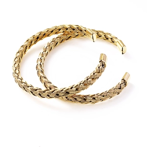 Detailed macro view of gold braided mesh texture on stainless steel open cuff bracelet