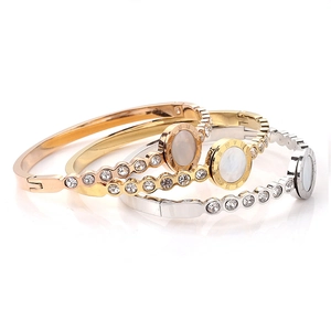Brazaletes con números romanos en oro, oro rosa y plata con nácar y circonitas