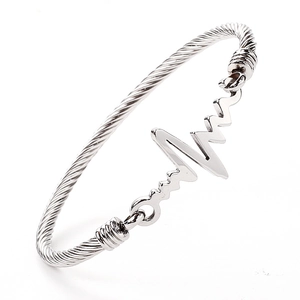 Close-up of twisted cable stainless steel bracelet featuring an EKG heartbeat charm
