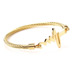 Golden stainless steel cable bracelet featuring a polished heart rate EKG wave design